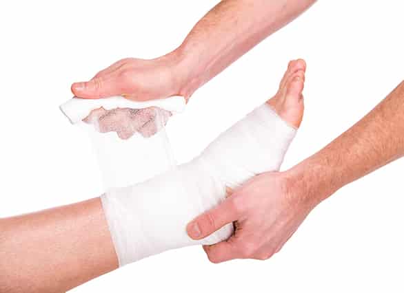 Close-up-man-is-putting-bandage-on-injured-feet_ Close-up-man-is-putting-bandage-on-injured-feet_