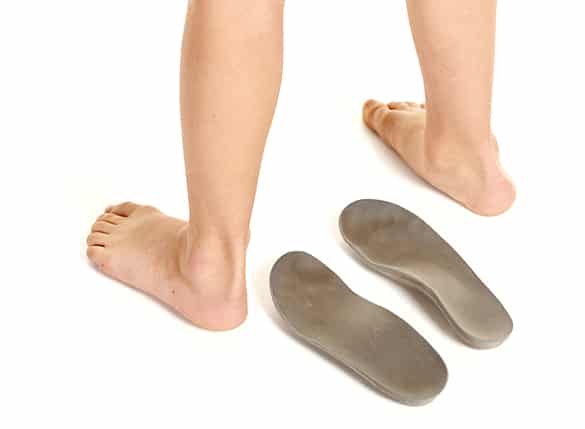 Orthopedic-insoles-and-little-boy-legs-on-white-background