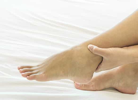 Woman-hand-holding-ankle-with-pain