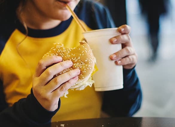 close-up-of-teenage-girl-eating-hamburger-obesity