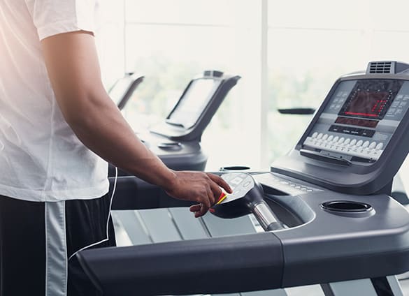 closeup-mans-hands-on-treadmill