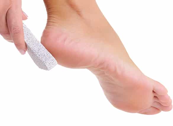 female-scrubbing-foot-by-pumice