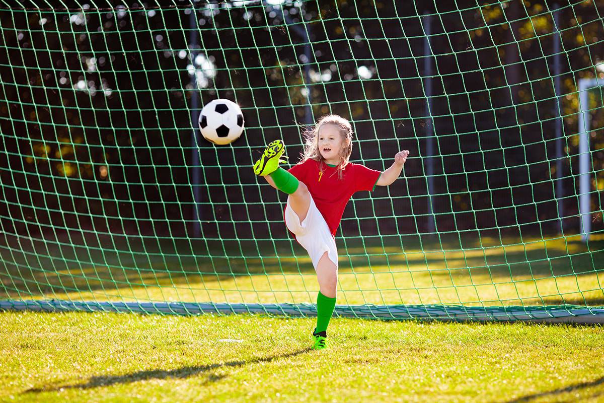 girl-soccer-kick-goalie