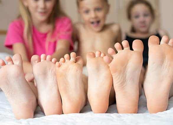 happy-brother-and-sisters-sitting-on-the-bed