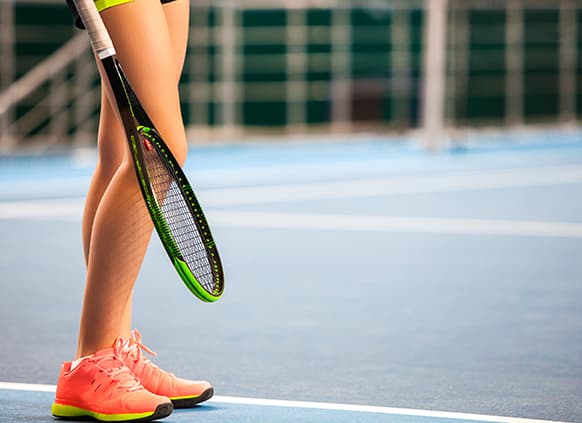 legs-of-young-girl-in-a-closed-tennis-court