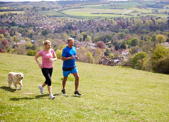mature-couple-with-golden-retriever-jogging