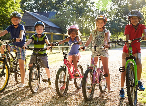 portrait-of-five-children-on-cycle-ride-together portrait-of-five-children-on-cycle-ride-together