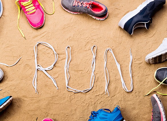 running-shoes-and-run-sign-made-of-shoelaces-sand running-shoes-and-run-sign-made-of-shoelaces-sand