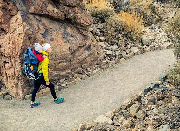 super-mom-with-baby-boy-hiking-in-backpack