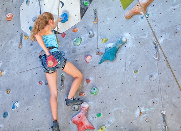 teenager-climbing-a-rock-wall
