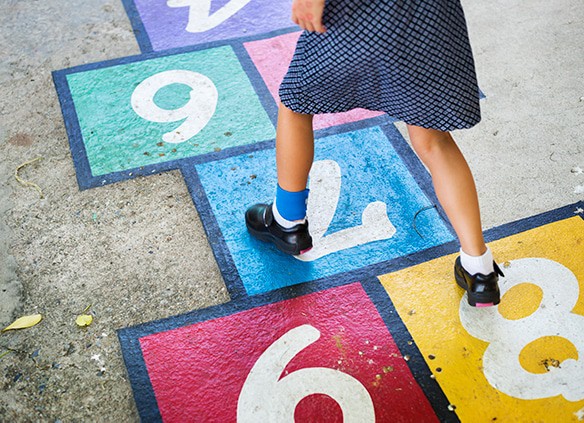 young-girl-playing-hopscotch-